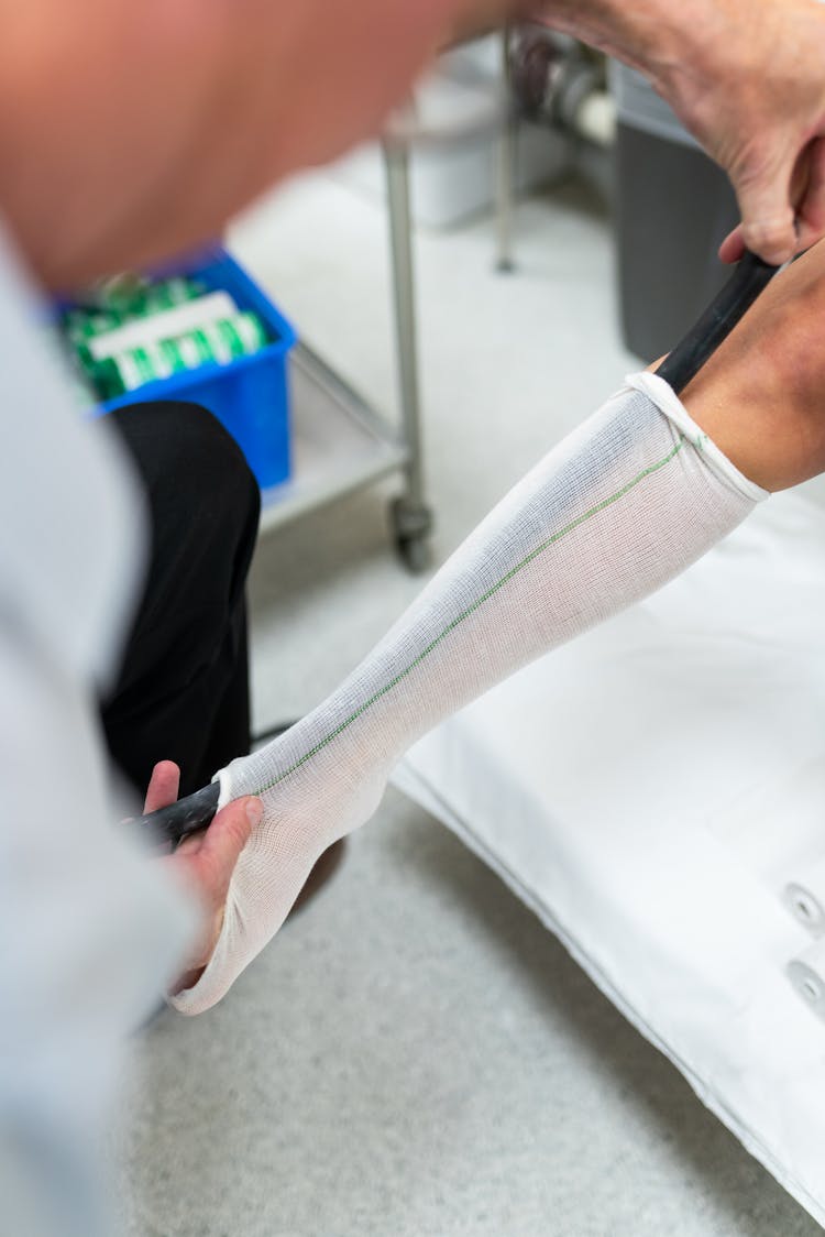 Person Measuring Patient Leg