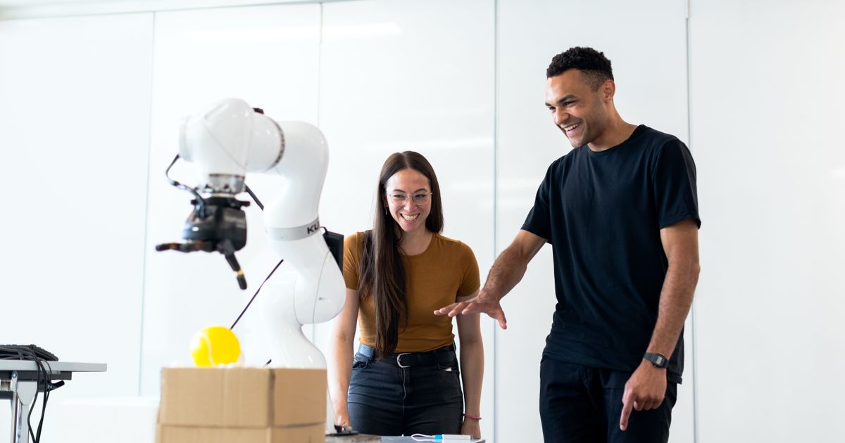 Engineers developing a robotic arm