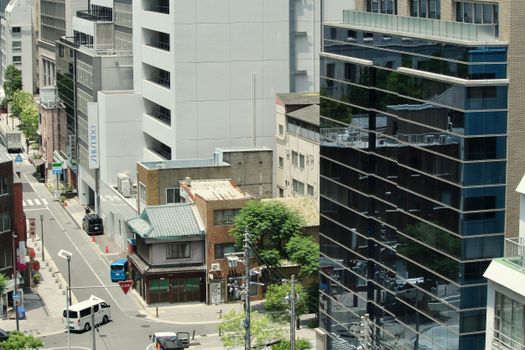 Aerial view of an Osaka city street with modern buildings and urban landscape.