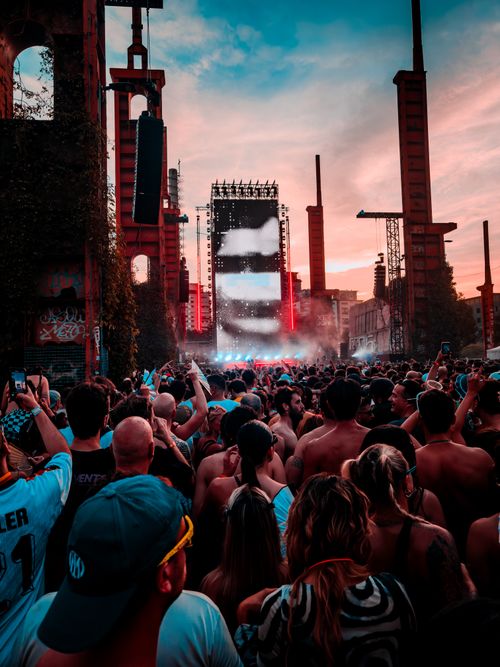 Free Dynamic crowd at a vibrant music festival in Turin during sunset, capturing the lively atmosphere. Stock Photo