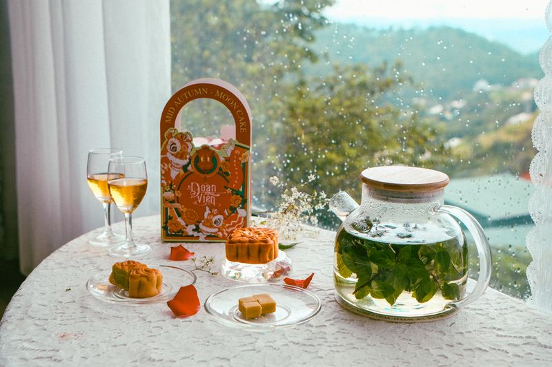 Mid-Autumn Festival tea and mooncakes arranged by a window with soft natural light