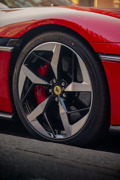 Free Detailed shot of a luxury sports car wheel, showcasing sleek design and high-performance features. Stock Photo