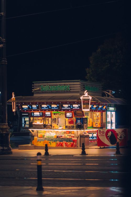 Free Colorful street food stall at night in Istanbul, showcasing local snacks and culture. Stock Photo