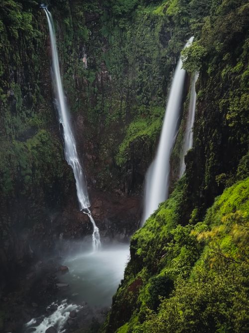 Free Breathtaking view of lush green waterfalls cascading in the serene Sahyadri Hills in Pune, India. Stock Photo