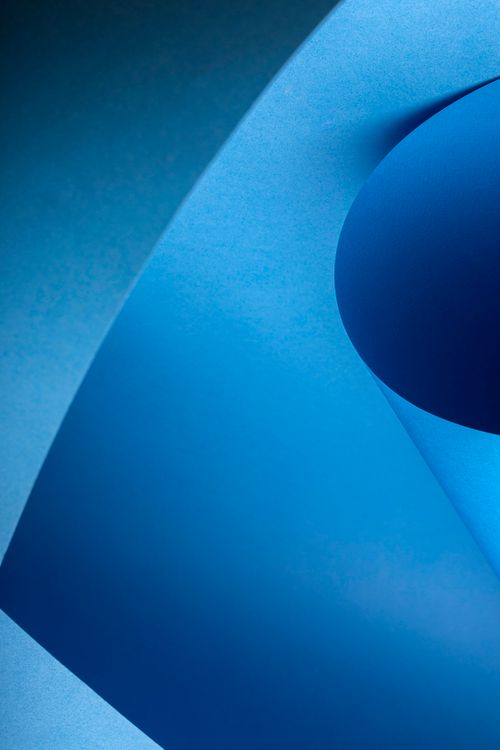 Free Abstract image featuring folded blue paper with curves and shadows. Stock Photo