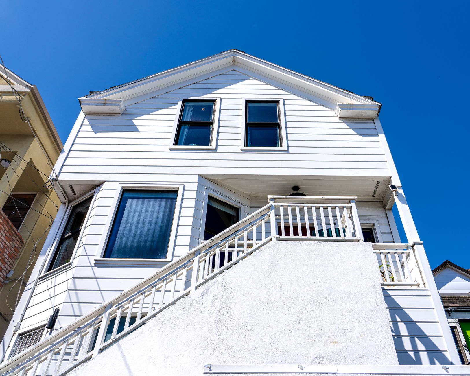 Bright view of a modern white house under clear blue sky in San Francisco.