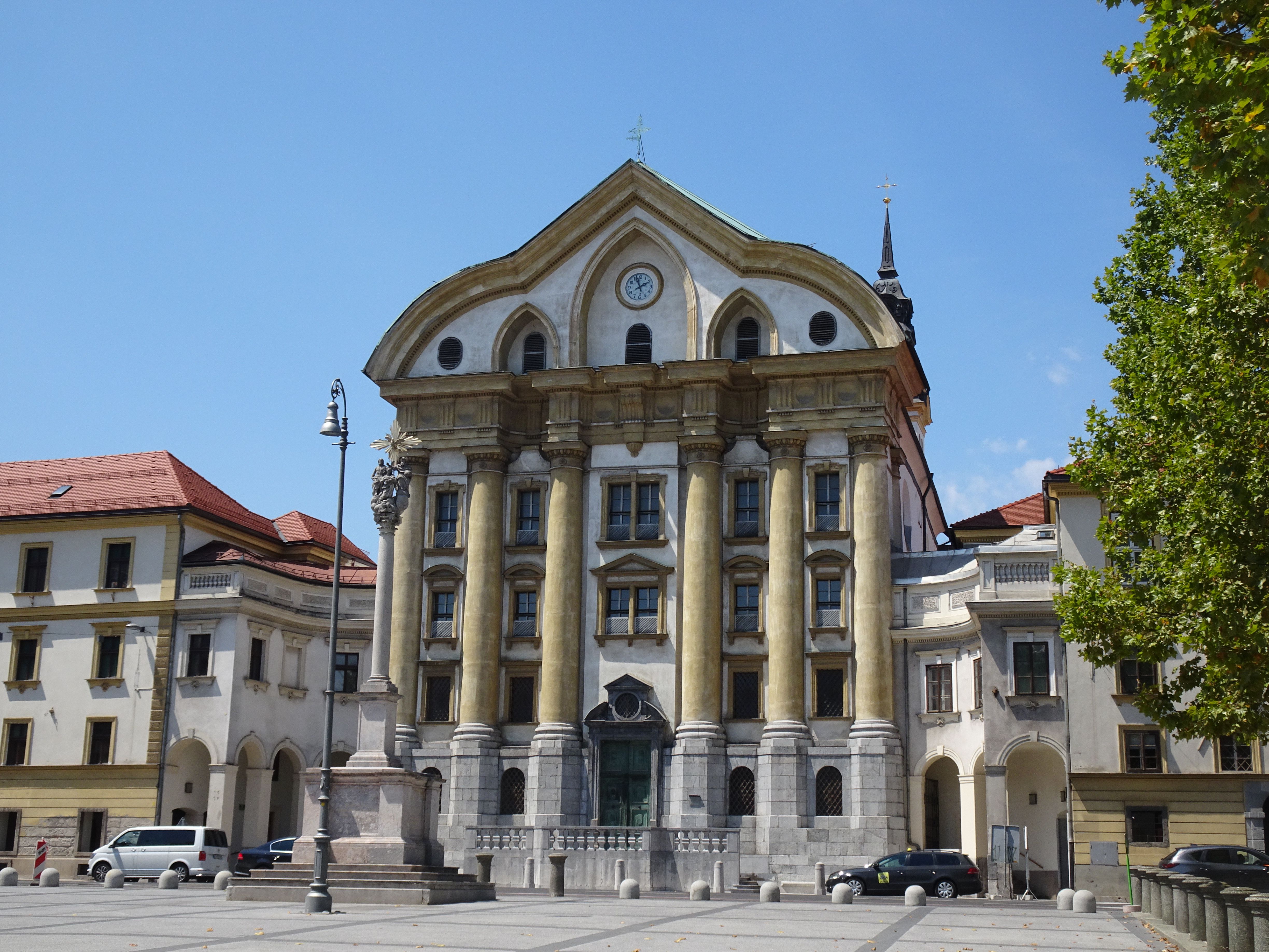 Stunning view of Historical Building in Ljubljana, Slovenia featuring Baroque architectural style under clear blue skies.