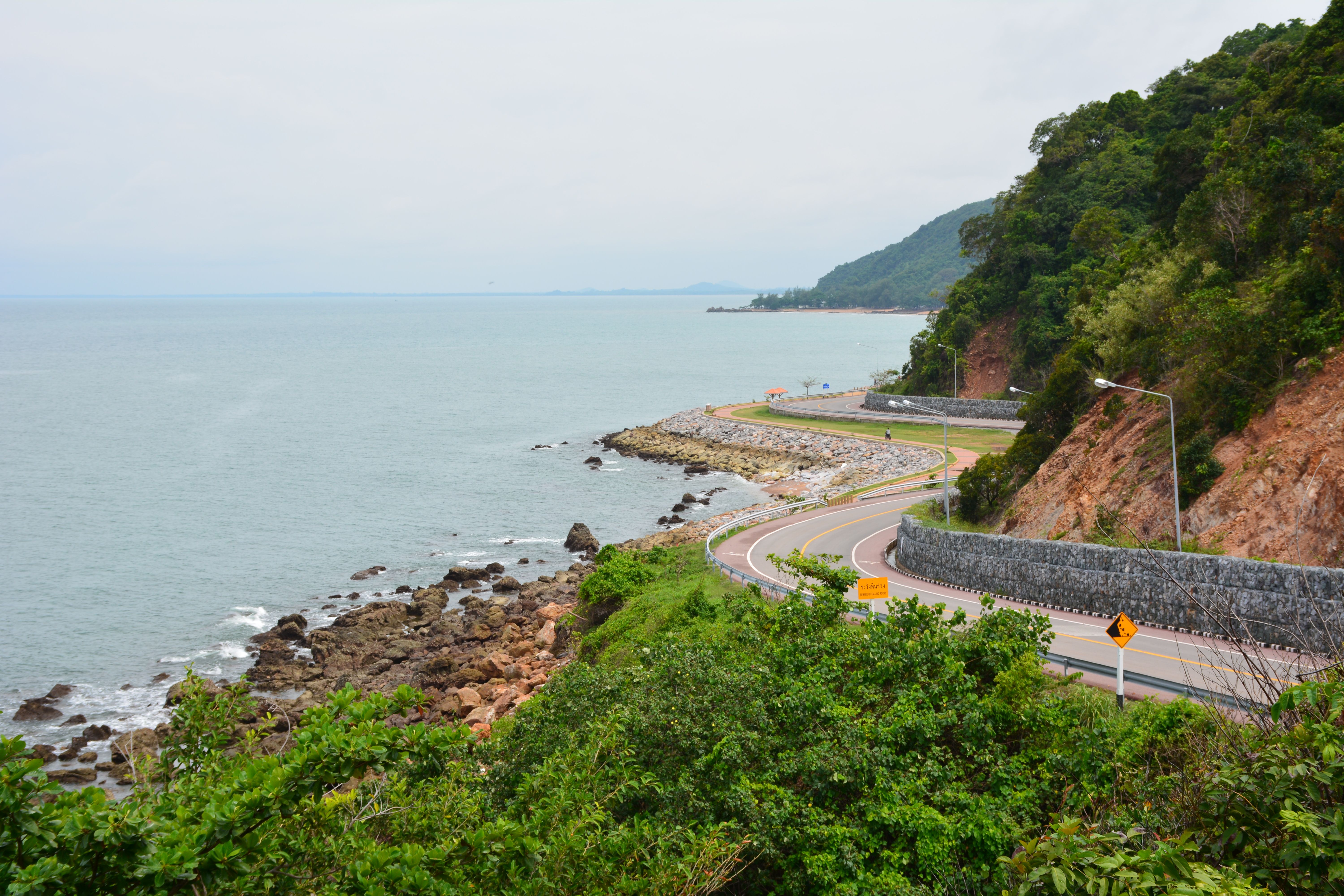 Winding coastal road along the sea in Chanthaburi, Thailand, offering stunning ocean views.