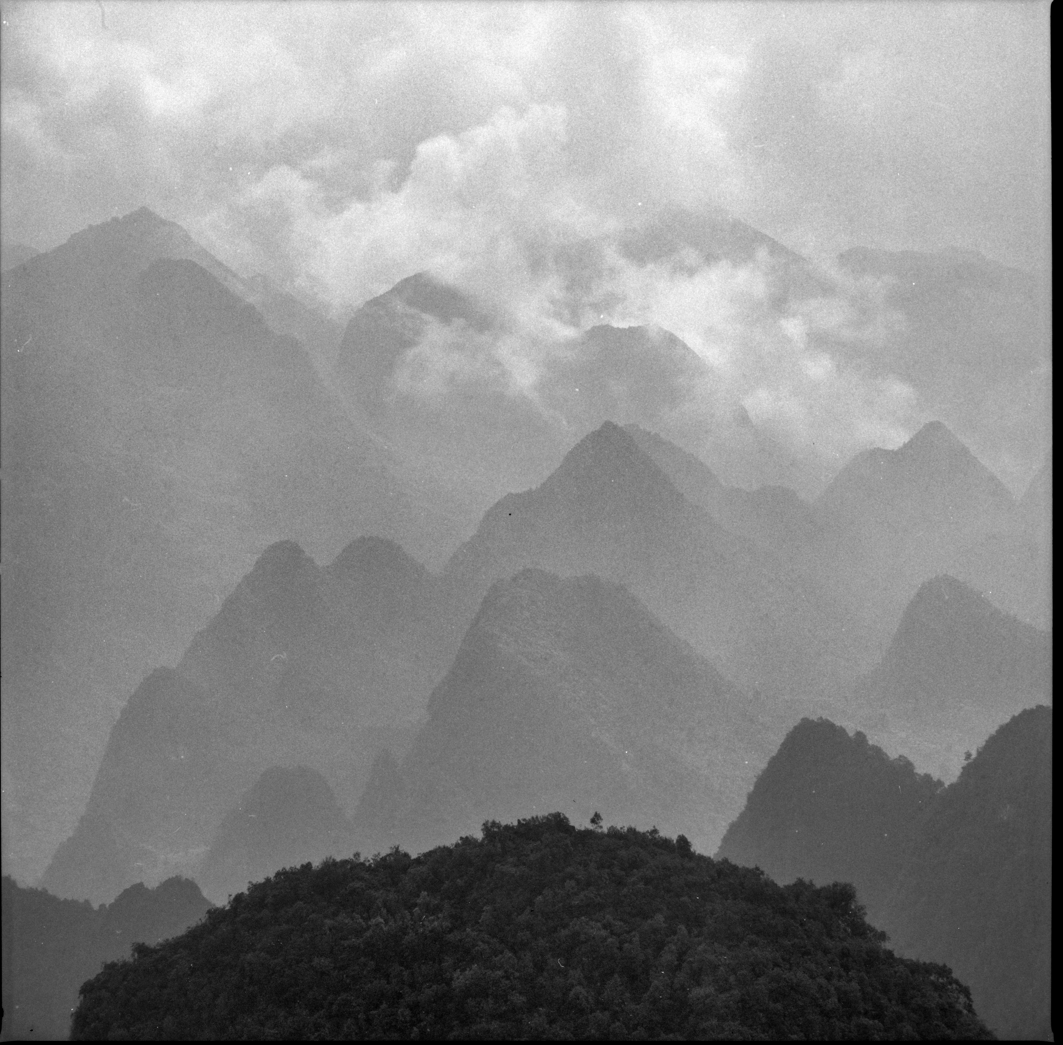 A captivating black and white view of misty mountains in Meo Vac, Vietnam.