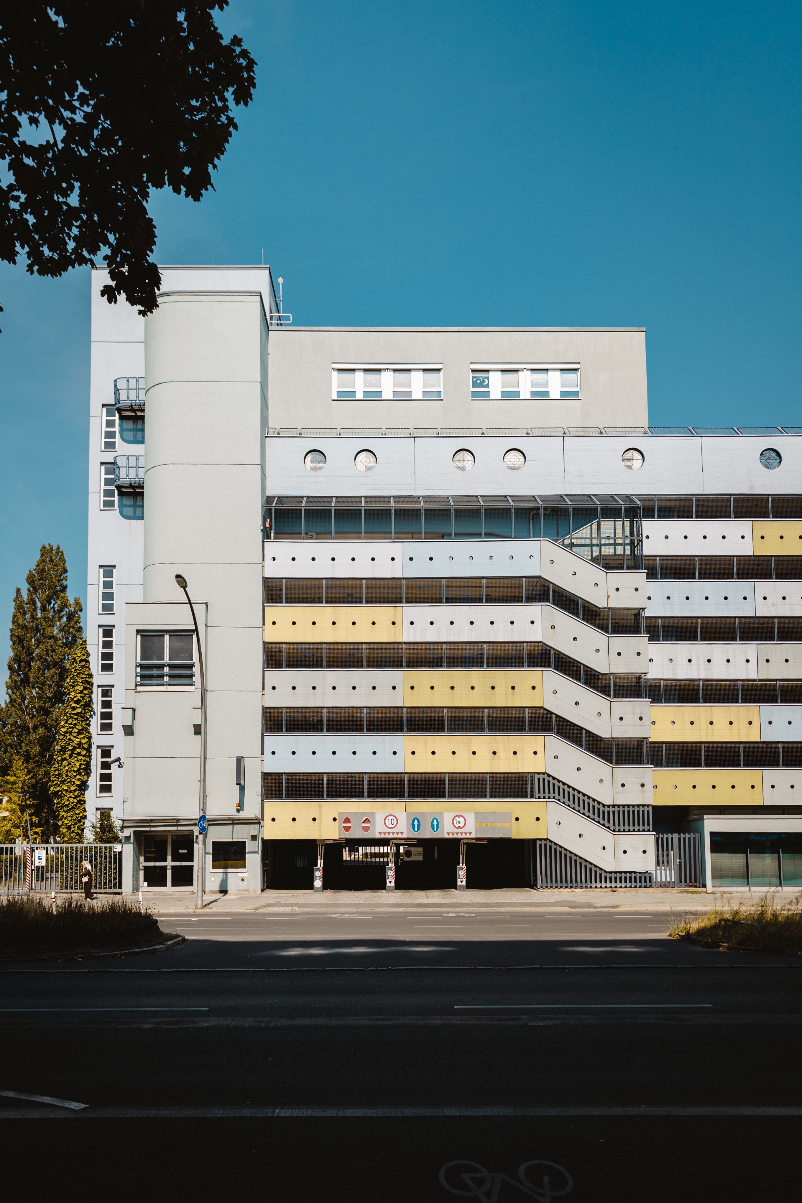 Contemporary parking structure under clear Berlin sky, showcasing urban architecture.