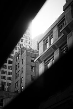 Black and white photo capturing Boston's intricate urban architecture with dramatic sunlight and shadows.