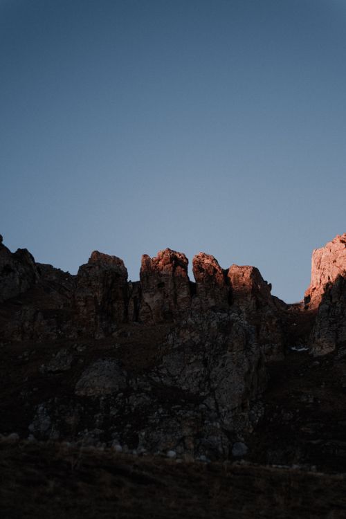 Free Dramatic sunset casting light on mountain rocks in Chechen Republic, Russia. Stock Photo