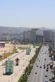 High-angle view of Tangier's vibrant cityscape with busy streets and modern architecture on a sunny day.