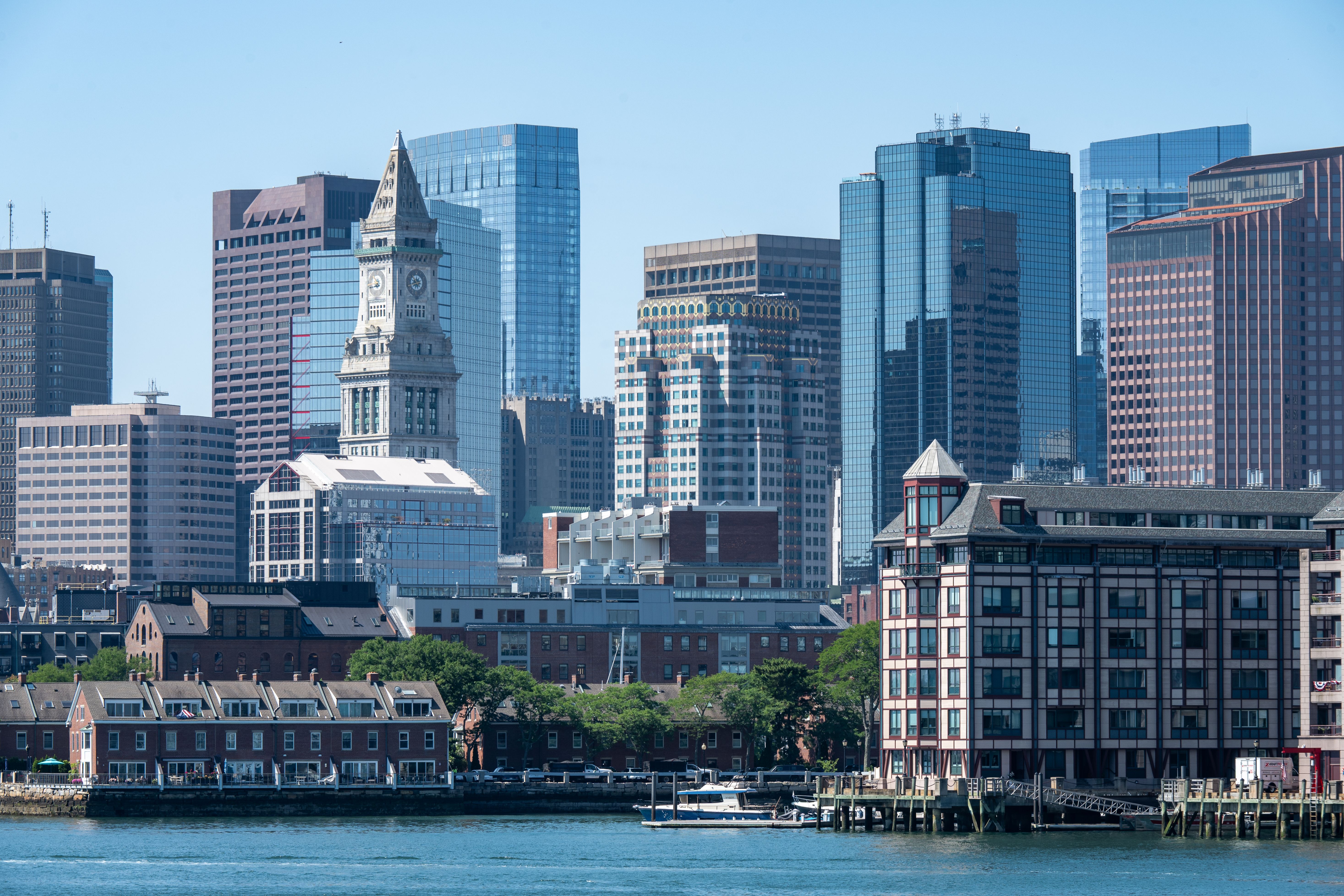 A vibrant view of Boston's skyline featuring the iconic Custom House Tower seen from the waterfront.