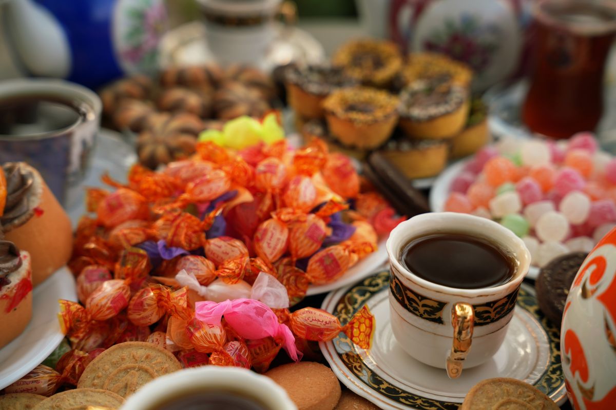 Enjoy a vibrant Persian tea spread with sweets and colorful pastries.