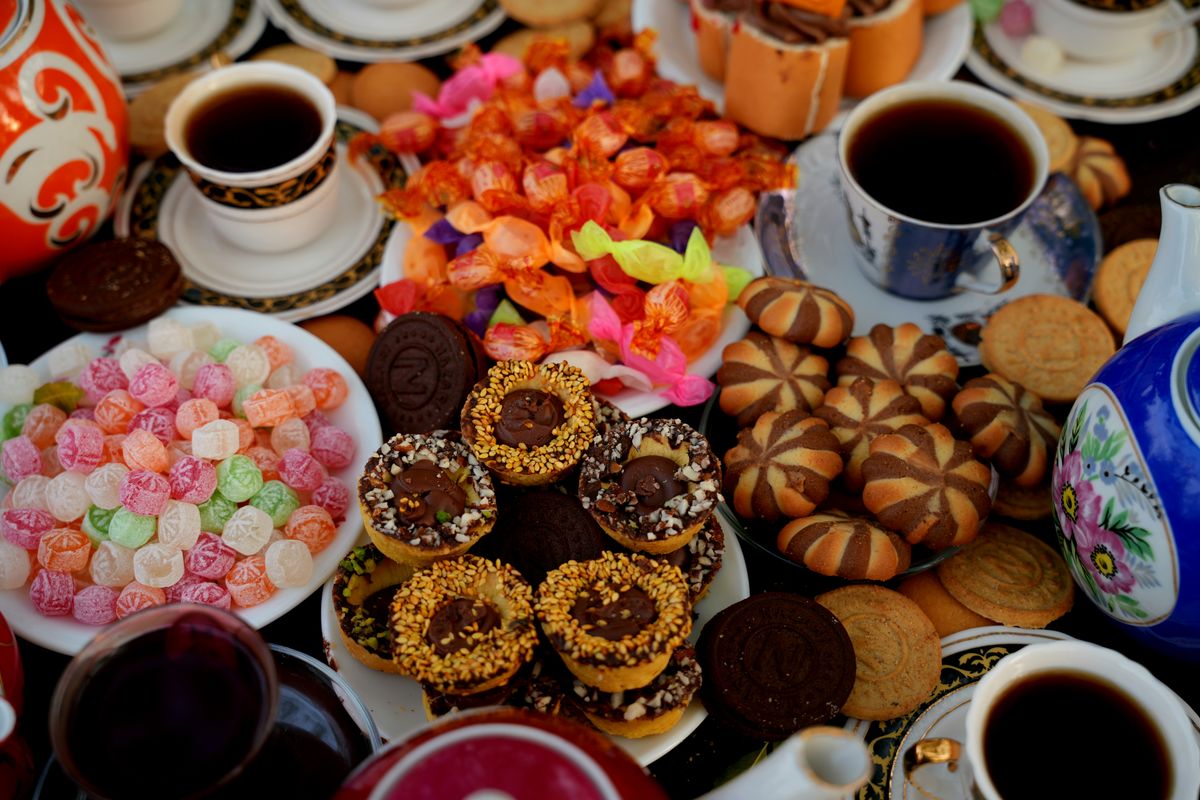 Delightful Persian tea setup with colorful sweets and pastries, ideal for afternoon tea.