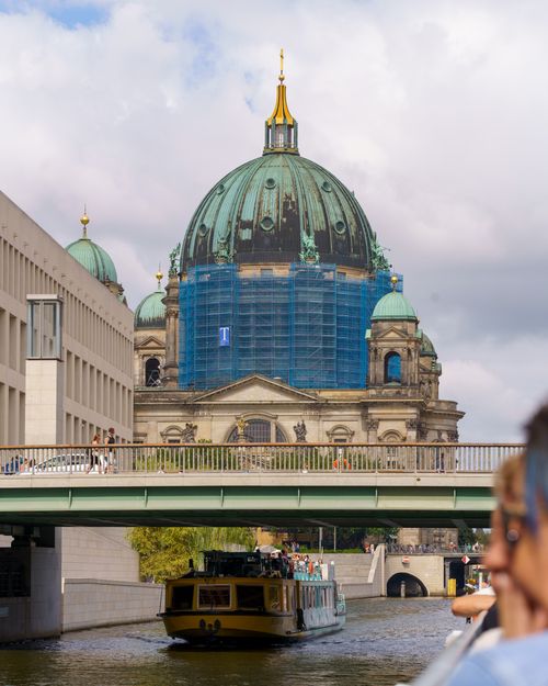 Free View of Berlin Cathedral covered in scaffolding, framed by a bridge and river. Stock Photo