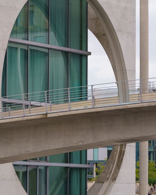 Free Close-up of a building's geometric facade with modern architectural elements and glass windows. Stock Photo
