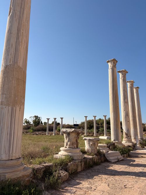 Free Majestic ancient Roman columns stand tall against a clear blue sky in Cyprus. Stock Photo