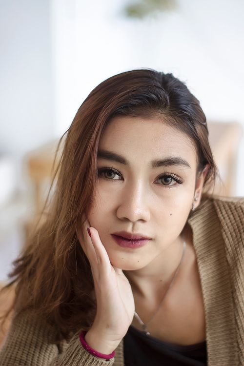 Free Close-up portrait of a woman indoors with thoughtful expression. Stock Photo