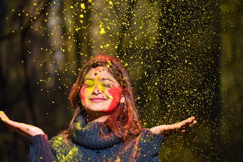 Woman In Blue Sweater Covered In Colored Powder