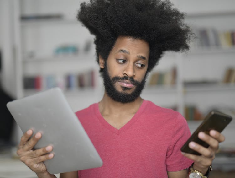 Man Holding Tablet And Smartphone