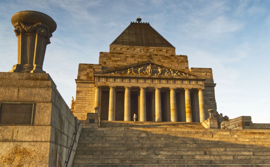 The majestic Shrine of Remembrance bathed in sunset light from below steps.