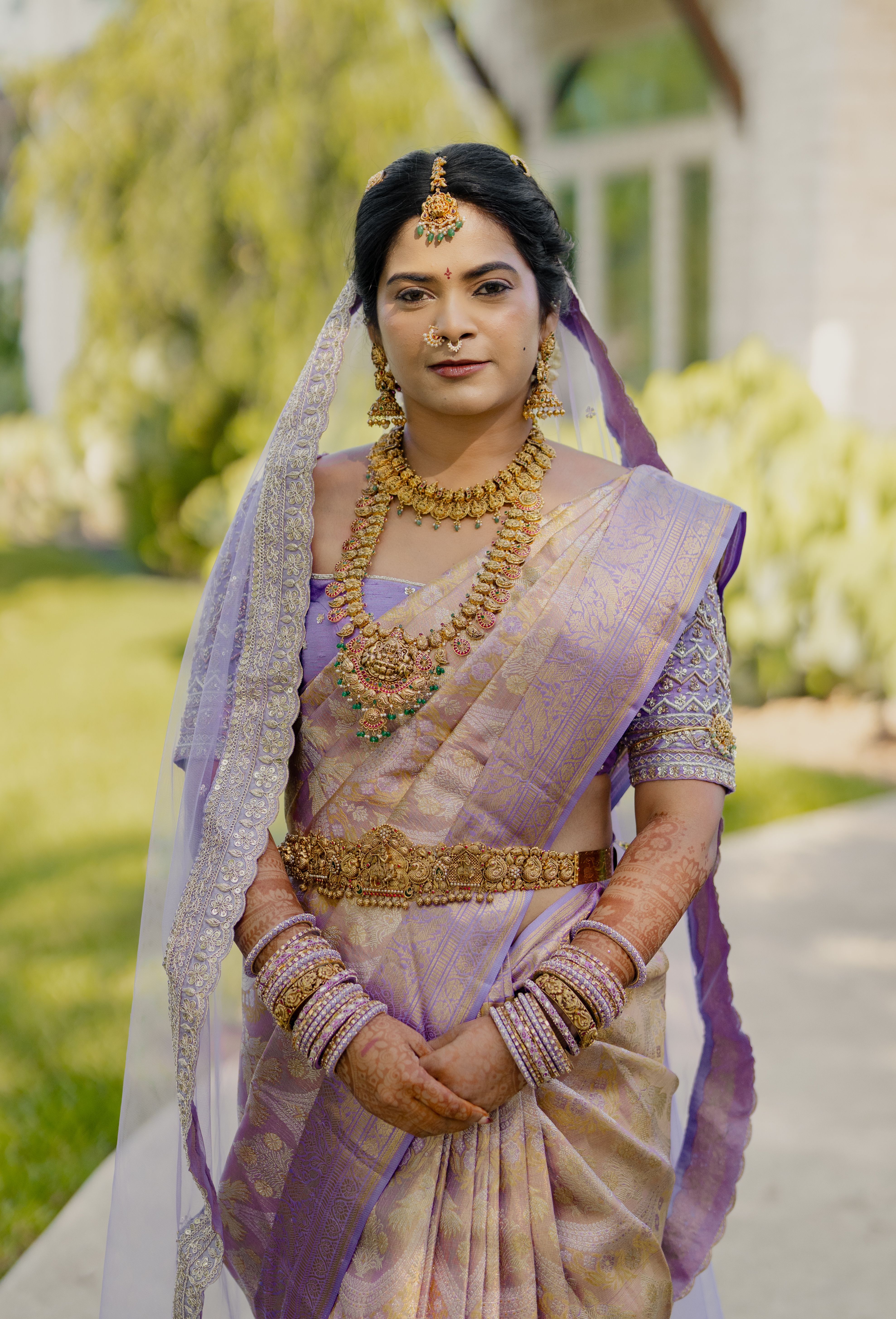 Bride in traditional attire with gold jewellery