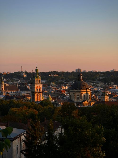 Free Captivating view of Lviv's skyline at sunset showcasing historic architecture and natural beauty. Stock Photo