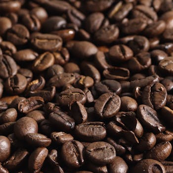 Rich and aromatic roasted coffee beans in a detailed close-up shot, perfect for caffeine lovers.