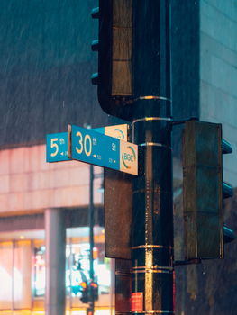 Street signs at BGC in Makati City captured on a rainy night.