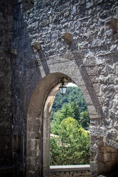 A stunning view through an ancient stone archway at Castel del Monte, showcasing Italian architecture.