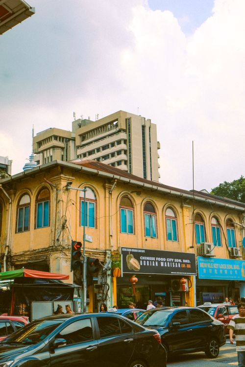 Free Bustling city street with historic buildings and modern high-rise in background. Stock Photo