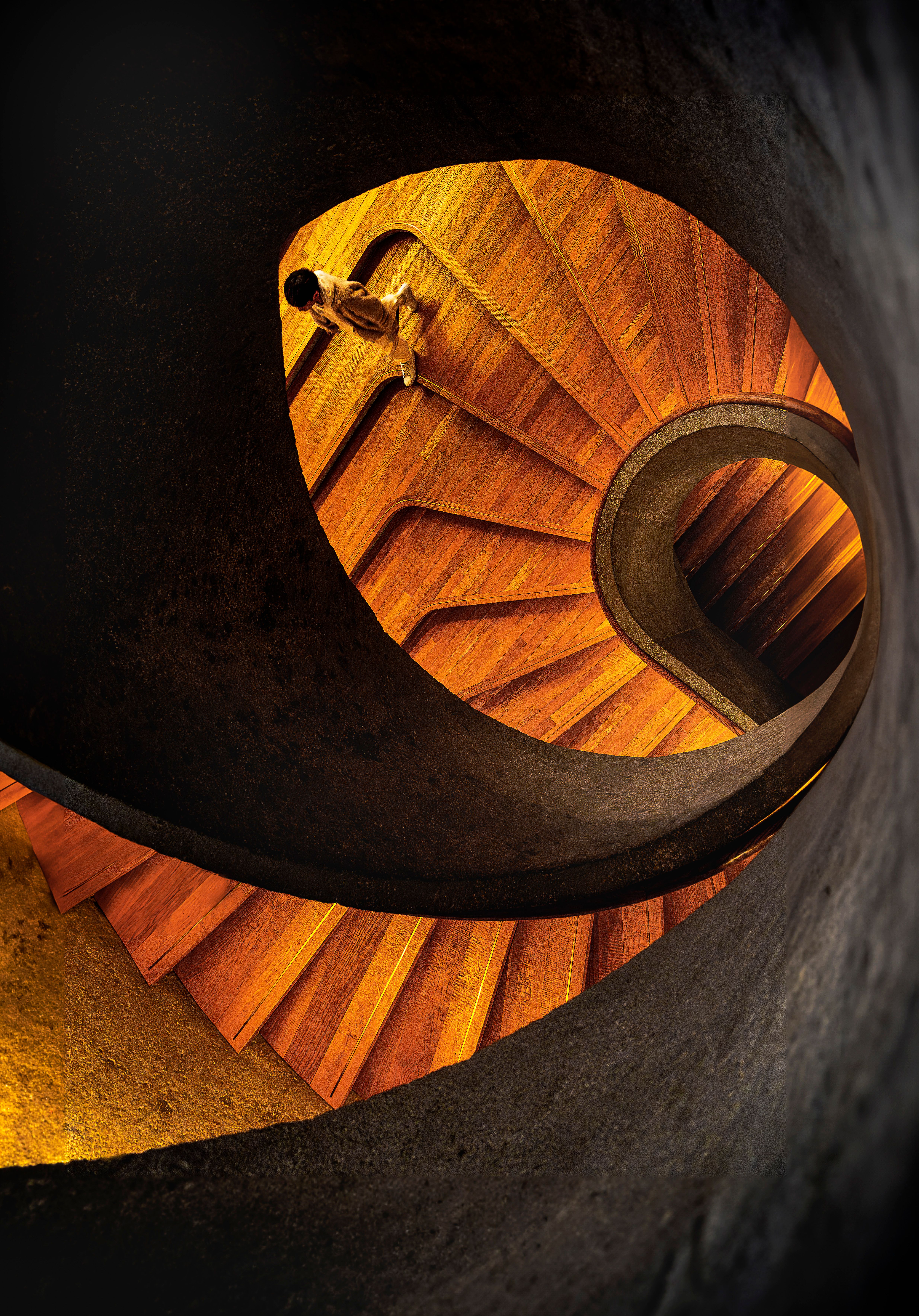 Capture of a person walking on a striking spiral staircase in Hong Kong.