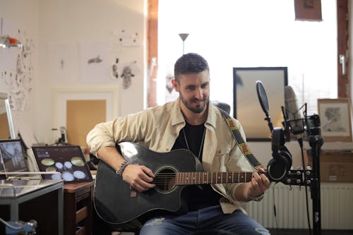 Man in Brown Button Up Shirt Playing Acoustic Guitar