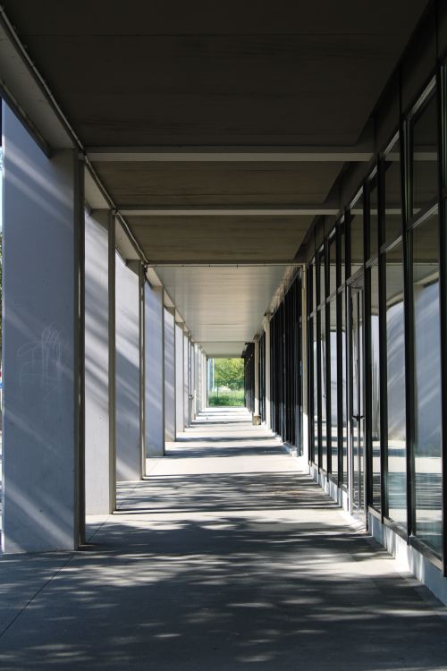 Free Symmetrical walkway in modern architecture with dramatic shadows. Stock Photo