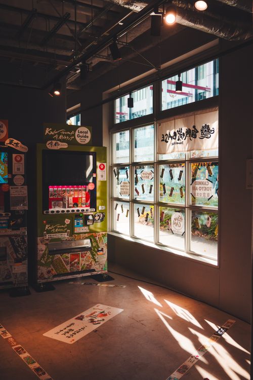 Free Interior of a Tokyo shop with a vending machine and sunlight filtering through windows. Stock Photo