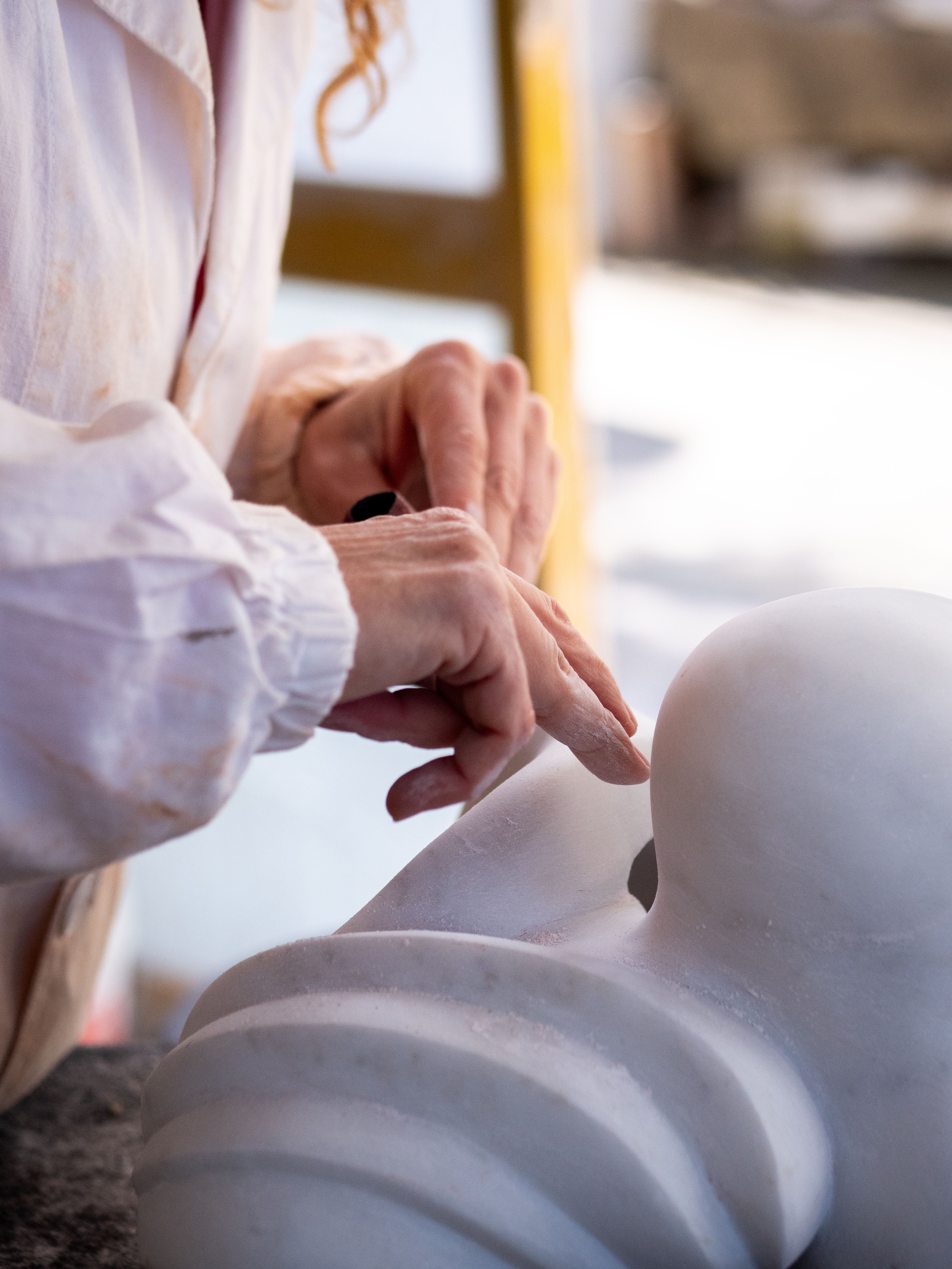 Detalle de una escultura en piedra clara, con la superficie trabajada a mano