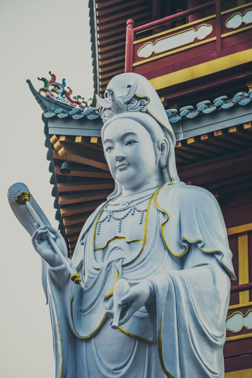 Free The majestic Buddha statue stands in front of the ornate Jakarta temple, epitomizing serenity and cultural heritage. Stock Photo