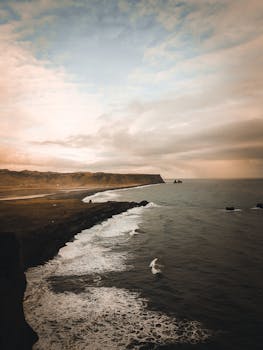 Experience the serene beauty of Iceland's rugged coastlines captured at dusk, showcasing nature's grandeur.