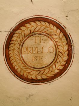 A circular wall inscription in an abandoned building in Портальрубио, Aragón, Spain.