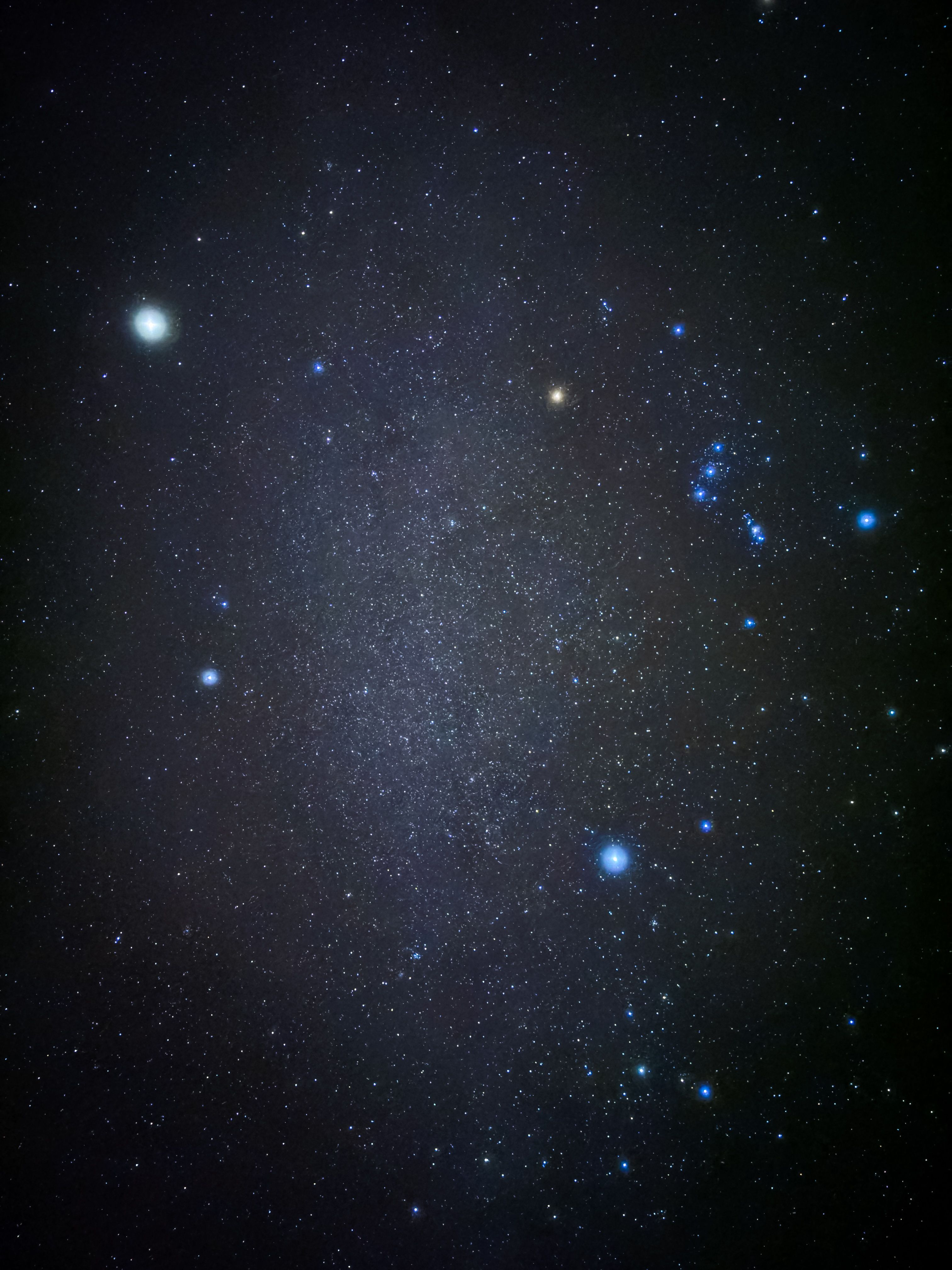 A vivid view of a starry night sky featuring the Orion constellation and celestial bodies.