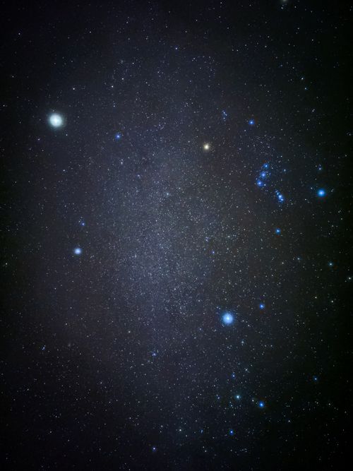 Free A vivid view of a starry night sky featuring the Orion constellation and celestial bodies. Stock Photo