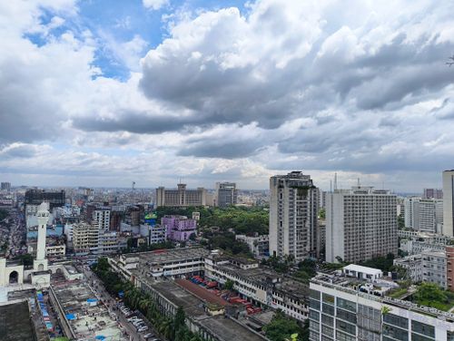 Free Aerial view of Dhaka's skyline under dramatic cloud formations, showcasing urban architecture. Stock Photo