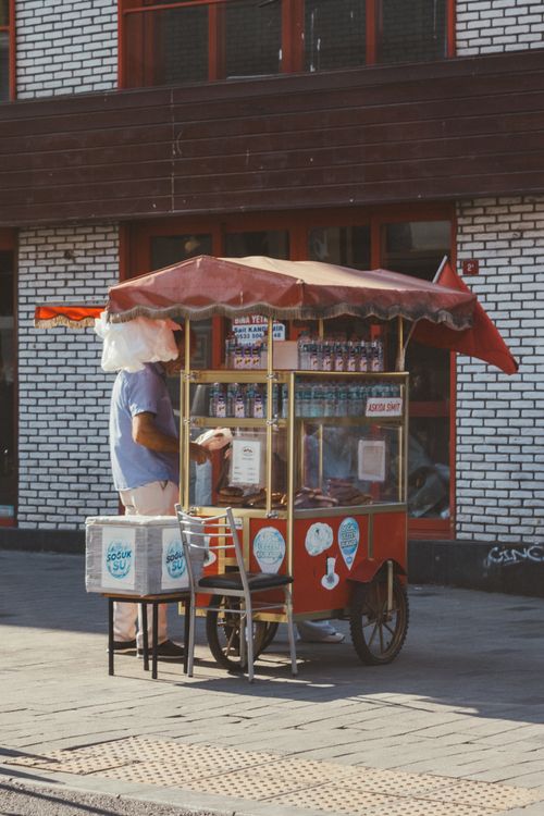 Free A street vendor with a traditional Turkish ice cream cart on a sunny day. Stock Photo