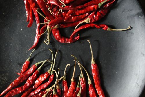 Free A vivid display of fresh red chili peppers on a contrasting dark background. Stock Photo