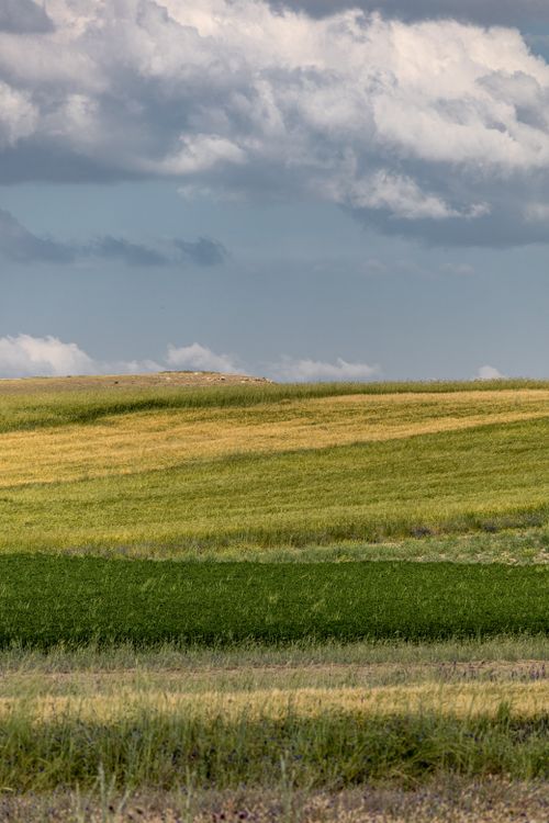 Free Vibrant landscape of layered fields under a dramatic sky in Kayseri, Türkiye. Stock Photo
