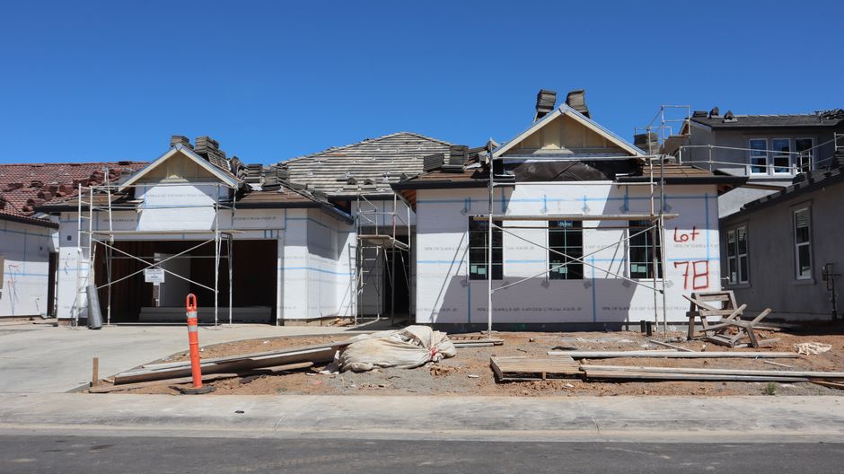 Photo by D Goug on Pexels Front view of a single-family home under construction with scaffolding and materials.