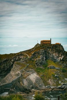 Dramatic landscape of San Juan de Gaztelugatxe in Spain with a winding path.