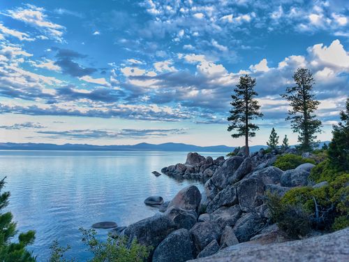 Free Beautiful scenic view of Lake Tahoe's rocky shoreline under a vibrant sky. Stock Photo